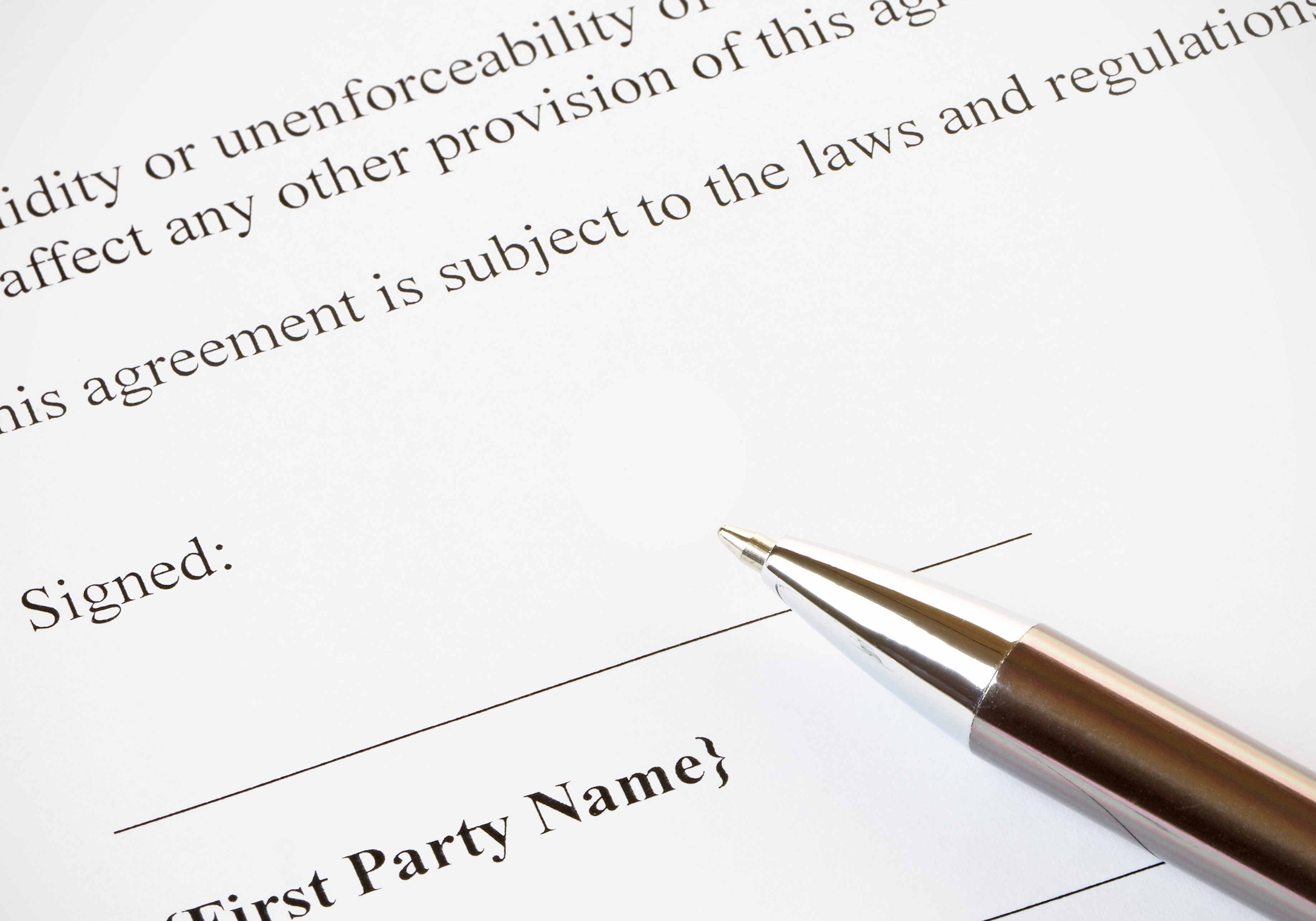 Contract and Pen Close up of a contract ready to be signed.With pen.Office,legal concept.